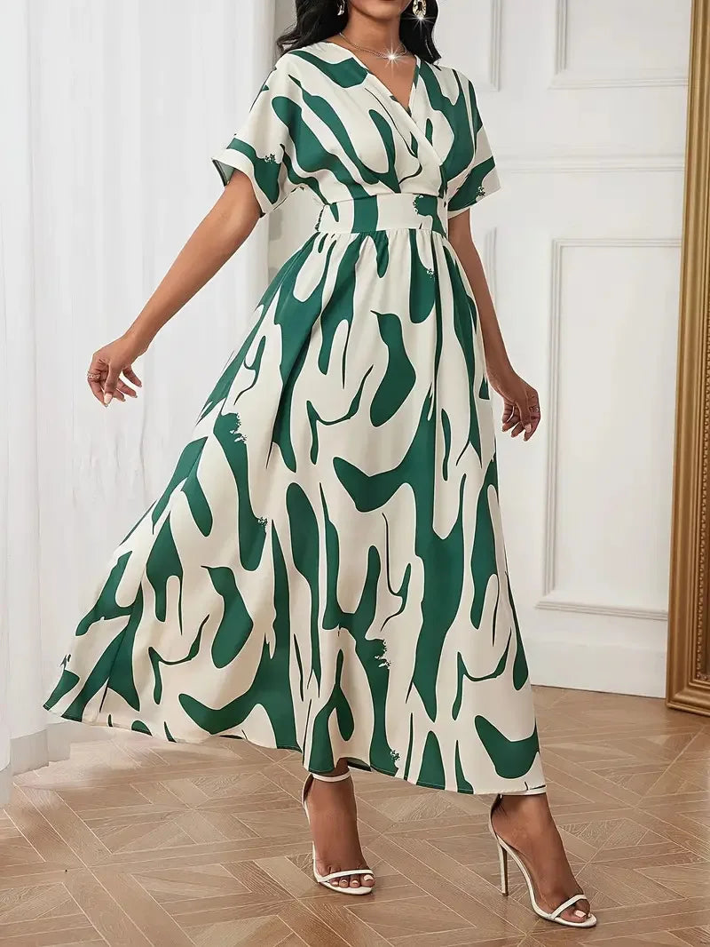 Woman wearing a green and white patterned dress in an indoor setting.