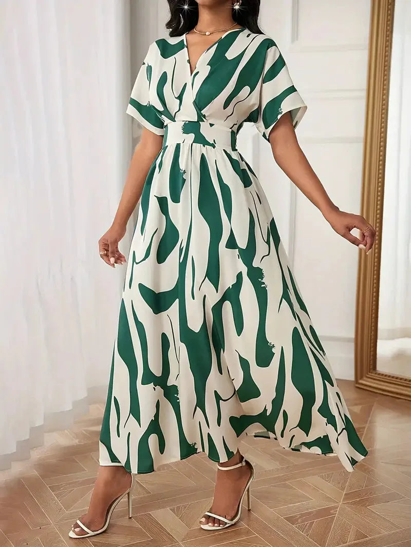 Woman wearing a green and white patterned dress indoors.