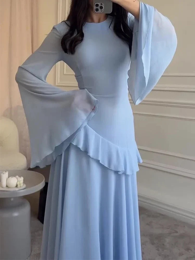 Light blue dress with ruffled sleeves and hem in a room setting