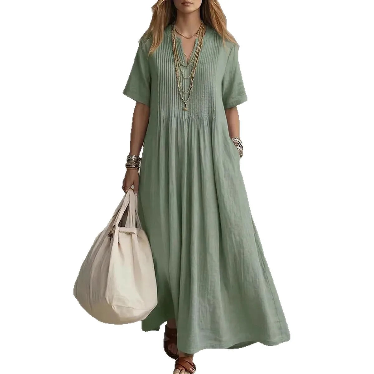 Woman wearing a green dress holding a beige tote bag on a white background
