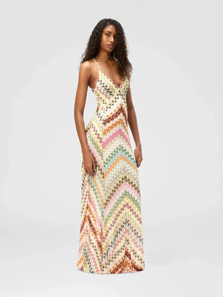 Woman wearing a colorful zigzag patterned dress on a light gray background