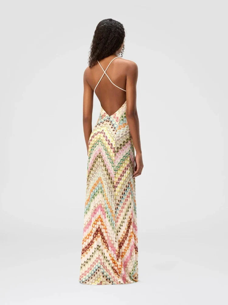 Woman wearing a colorful zigzag patterned dress on a light gray background