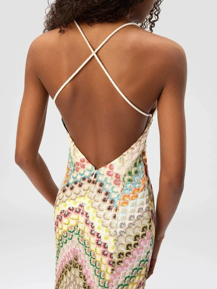 Multicolored patterned dress with criss-cross back design on a plain background
