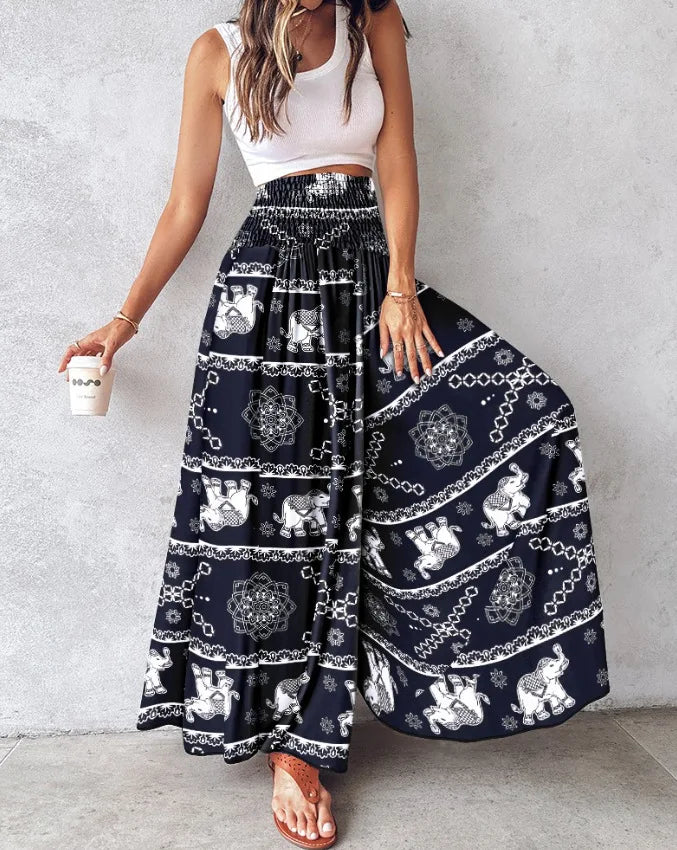 Person wearing a navy blue patterned skirt with a white top against a light gray background