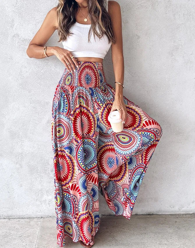 Woman wearing colorful patterned pants against a plain background