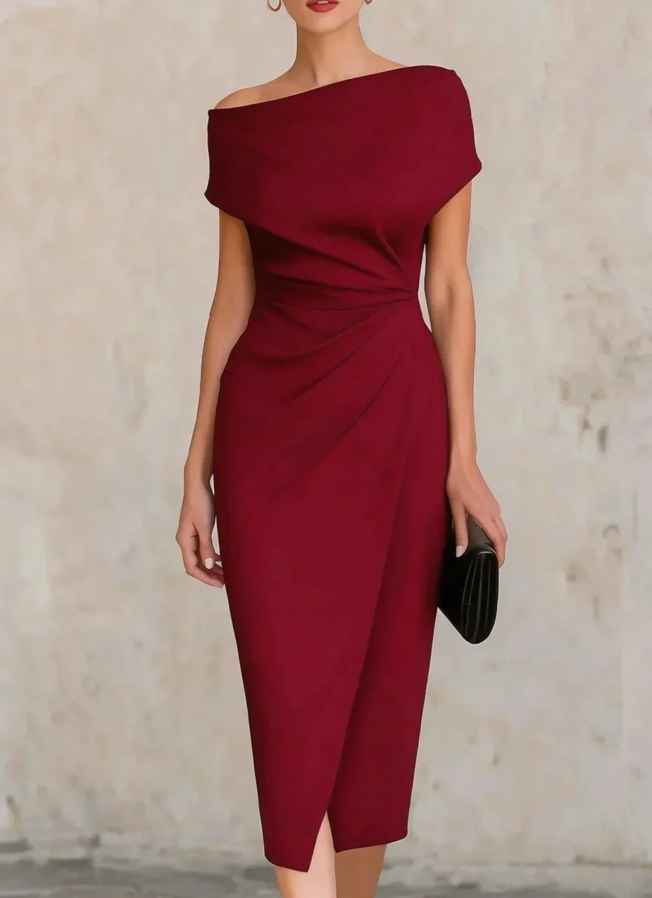 Woman wearing a burgundy off-shoulder dress against a neutral background