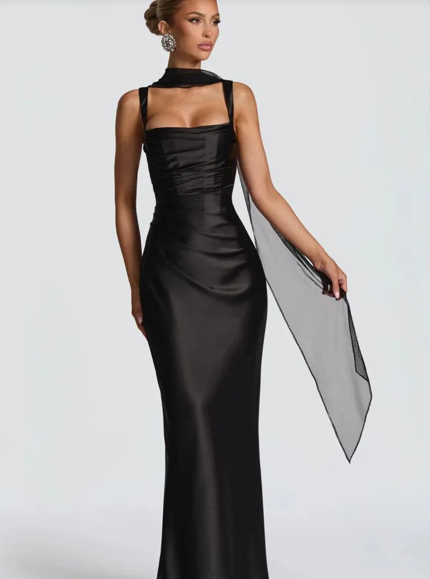 Woman wearing a black evening gown with a white background