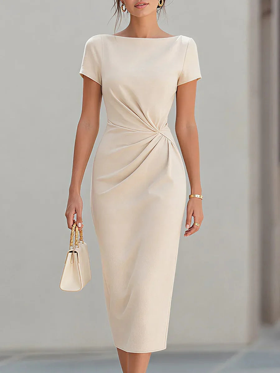 A woman models a short-sleeve midi dress in a warm cream or off-white shade. The dress features a boat neckline, short sleeves, and a distinctive gathered twist detail at the waist.