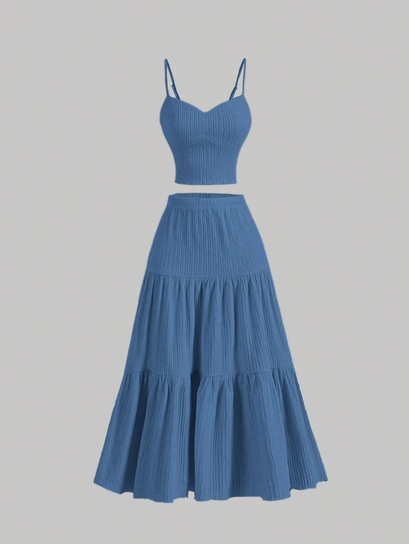 Blue two-piece outfit with a top and tiered skirt on a gray background