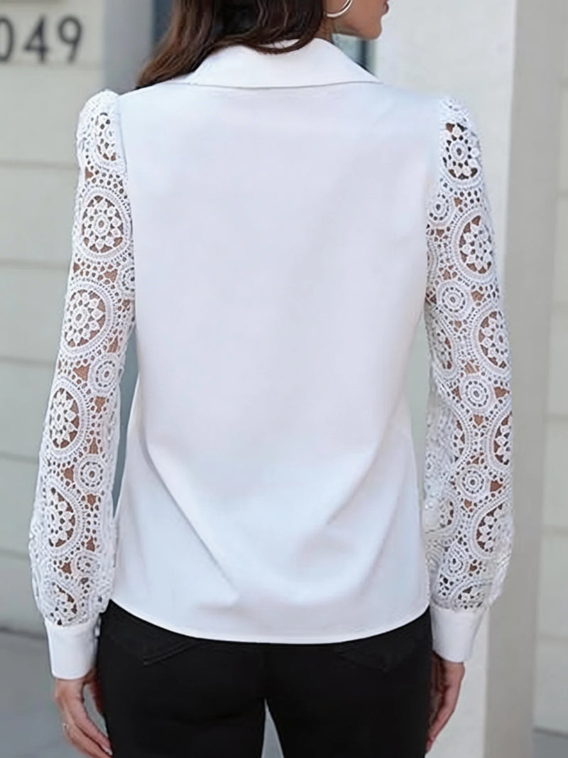 White blouse with lace sleeves worn by a person, blurred background