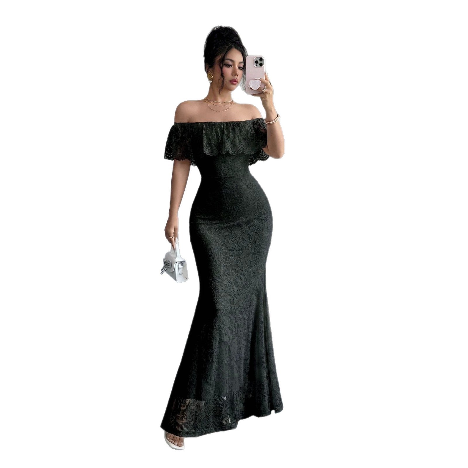 A woman takes a mirror selfie wearing a black off-the-shoulder lace maxi dress with a ruffled neckline and a fitted mermaid silhouette. She is holding a small white handbag against a plain white background.