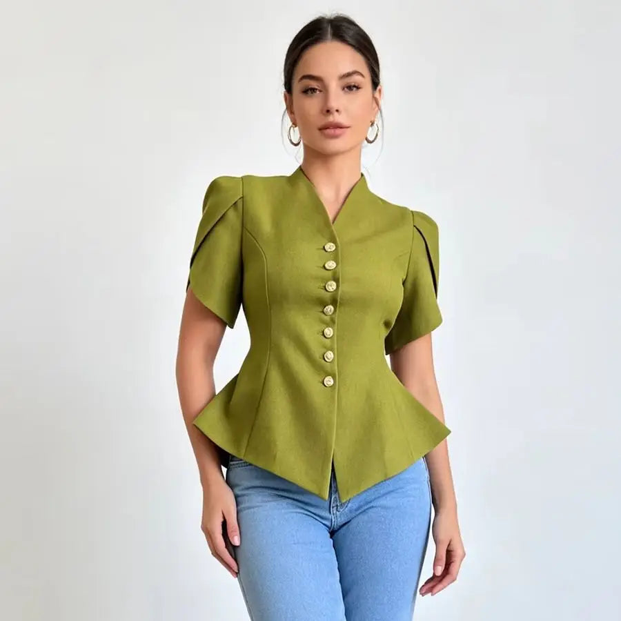 A woman modeling a short-sleeved olive green peplum blouse with a button-down front and structured shoulders, paired with light blue jeans against a plain light gray background.